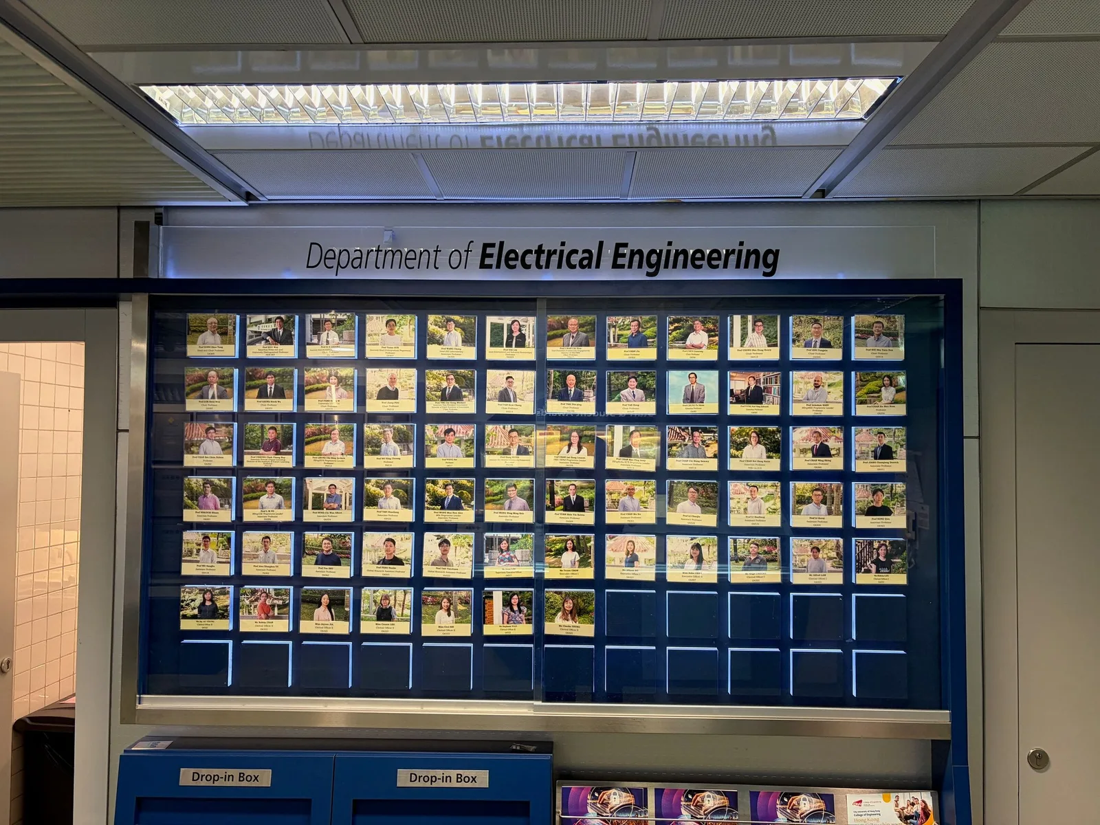 The wall of the Department of Electrical Engineering displays photos and names of all its staff.